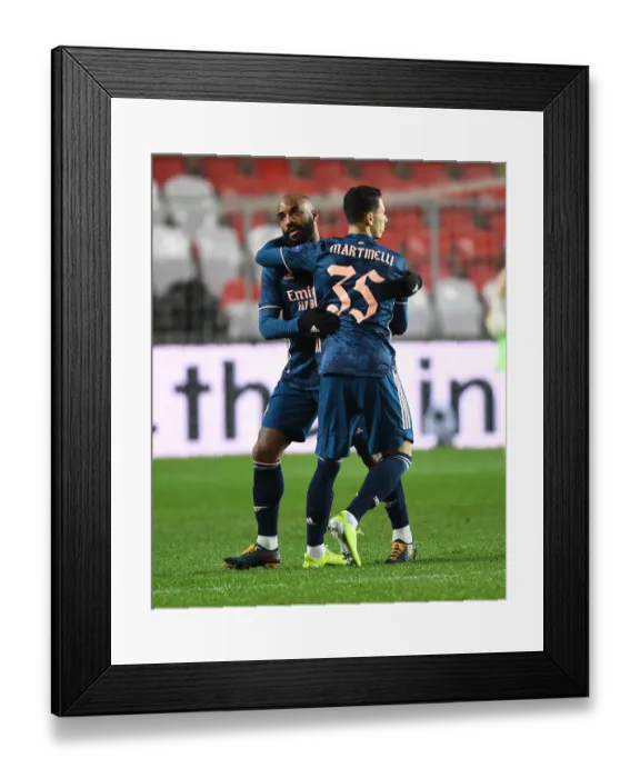 Framed Print : Arsenal's Emotional Reunion: Martinelli and Lacazette Hug It Out in Empty Eden Arena during Europa League Quarterfinal