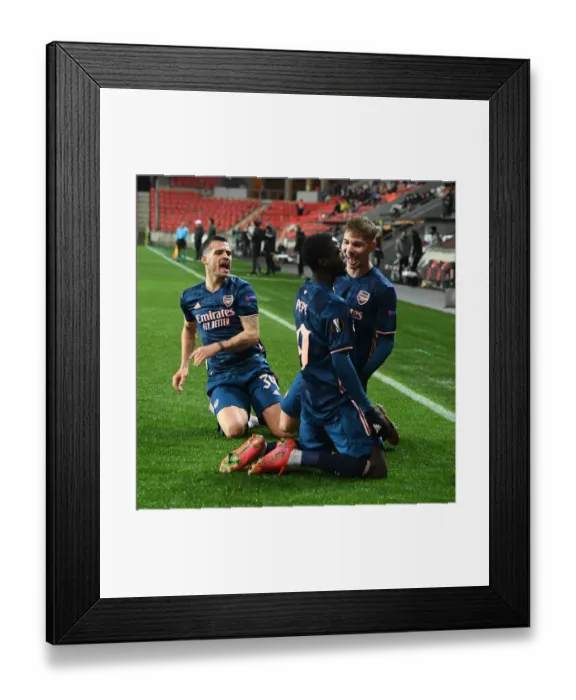 Framed Print : Arsenal's Nicolas Pepe Scores in Empty Eden Arena: Securing Europa League Quarterfinal Victory over Slavia Prague