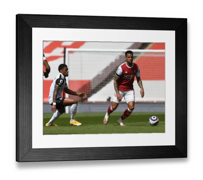 Framed Print : Arsenal's Gabriel Magalhaes Clashes with Fulham's Ivan Cavaleiro in Empty Emirates Stadium - Arsenal v Fulham, 2021 Premier League
