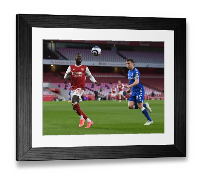 Framed Print : Arsenal's Nicolas Pepe Clashes with Everton's Seamus Coleman in Premier League Showdown