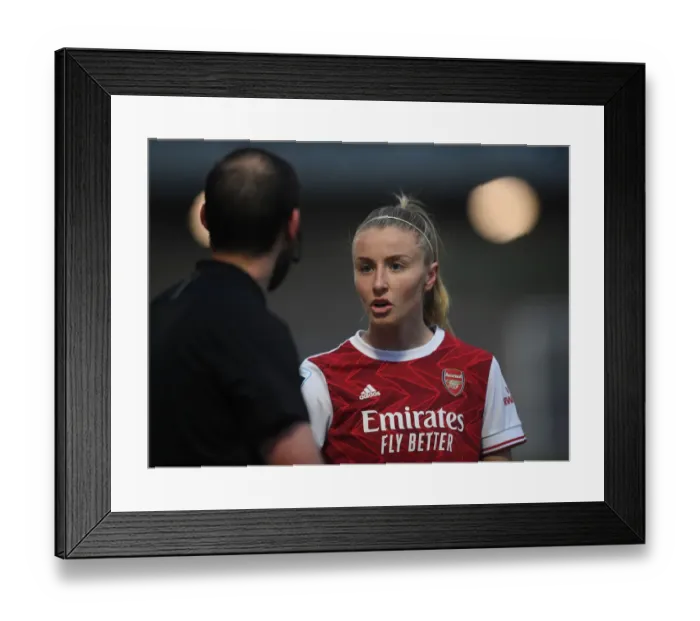 Framed Print : Arsenal's Leah Williamson Engages with Assistant Referee Amid Empty Meadow Park (FA WSL 2021)