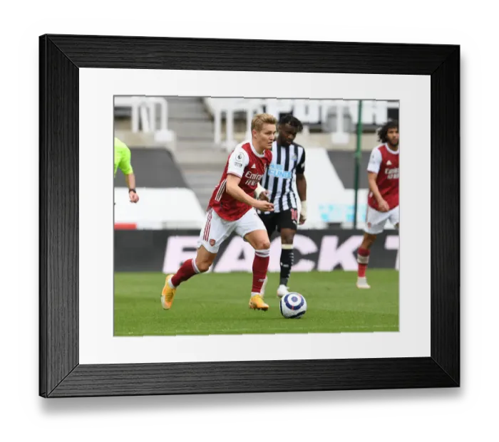 Framed Print : Arsenal's Martin Odegaard at Newcastle United: Premier League Clash Amidst Empty St. James Park (2020-21)