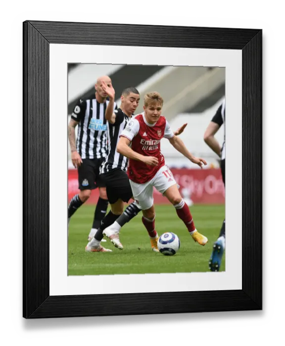 Framed Print : Arsenal's Martin Odegaard Outmaneuvers Newcastle's Miguel Almiron in Empty St. James Park