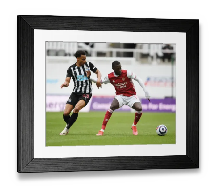 Framed Print : Arsenal's Pepe vs Murphy: A Battle at Empty St. James Park (Newcastle United vs Arsenal 2021)