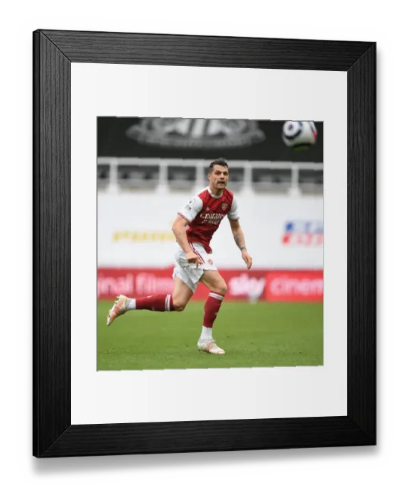 Framed Print : Granit Xhaka's Brilliant Performance: Arsenal's Midfield Masterclass at Empty St. James Park vs. Newcastle United, Premier League 2020-21