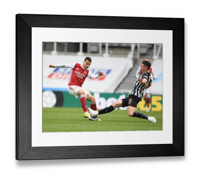 Framed Print : Clash at St. James Park: Arsenal's Martinelli Faces Off Against Newcastle's Schar in Empty Premier League Arena