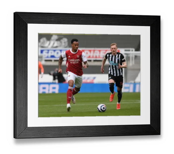 Framed Print : Gabriel Magalhaes vs. Sean Longstaff: A Battle at St. James Park in Empty Premier League Stadiums (Newcastle United vs. Arsenal, 2021)