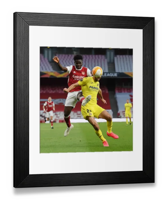Framed Print : Bukayo Saka's Europa League Battle: Arsenal vs. Villarreal in Empty Emirates Stadium
