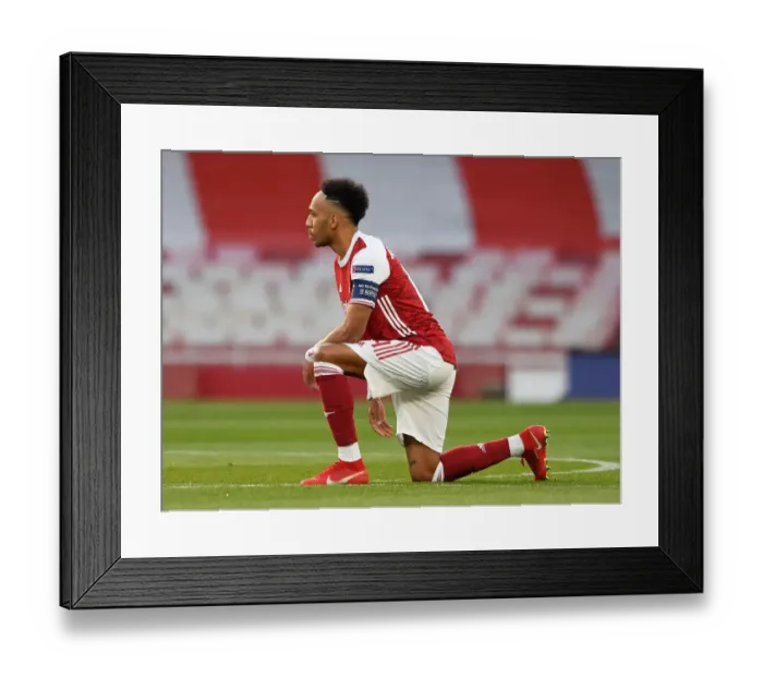Framed Print : Arsenal's Aubameyang Takes a Knee in Empty Emirates Stadium during Europa League Semi-Final vs Villarreal Framed Print : Arsenal's Aubameyang Takes a Knee in Empty Emirates Stadium during Europa League Semi-Final vs Villarreal