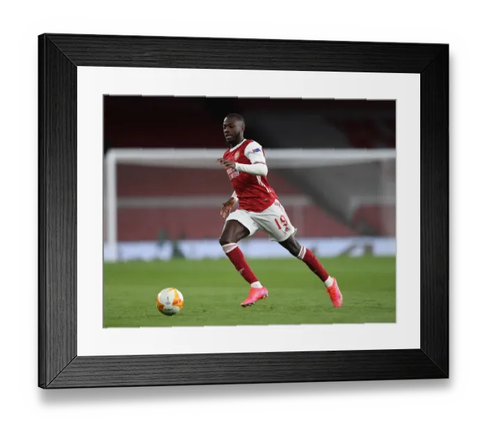 Framed Print : Behind Closed Doors: Arsenal's Nicolas Pepe in UEFA Europa League Semi-Final vs Villarreal CF