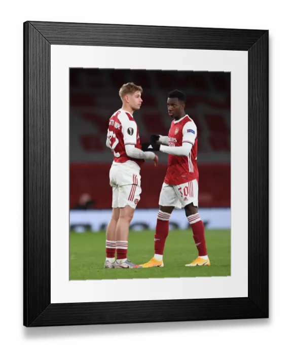 Framed Print : Arsenal's Emile Smith Rowe and Eddie Nketiah Celebrate Semi-Final Advancement vs. Villarreal in Empty Emirates Stadium