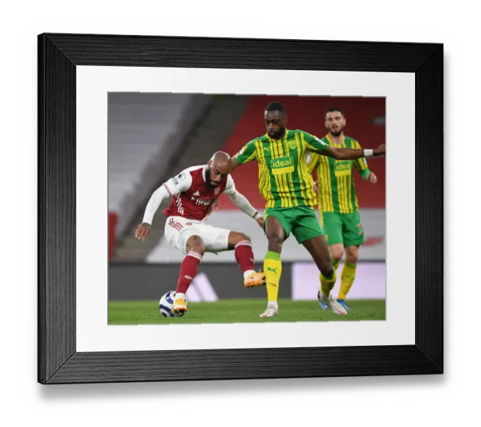 Framed Print : Lacazette vs. Ajayi: A Battle Unseen - Arsenal vs. West Bromwich Albion in Empty Emirates, Premier League (2020-21)