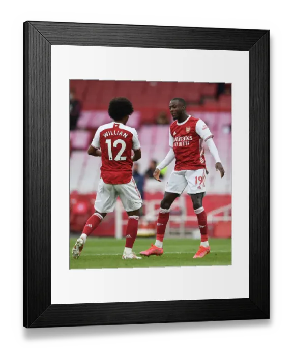 Framed Print : Arsenal's Pepe and Willian Celebrate Goals Amidst Empty Emirates Stadium Against West Bromwich Albion (2020-21)