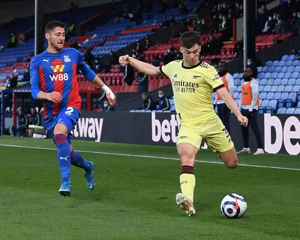 Arsenal's Kieran Tierney Faces Pressure from Crystal Palace's Joel Ward During Premier League Clash