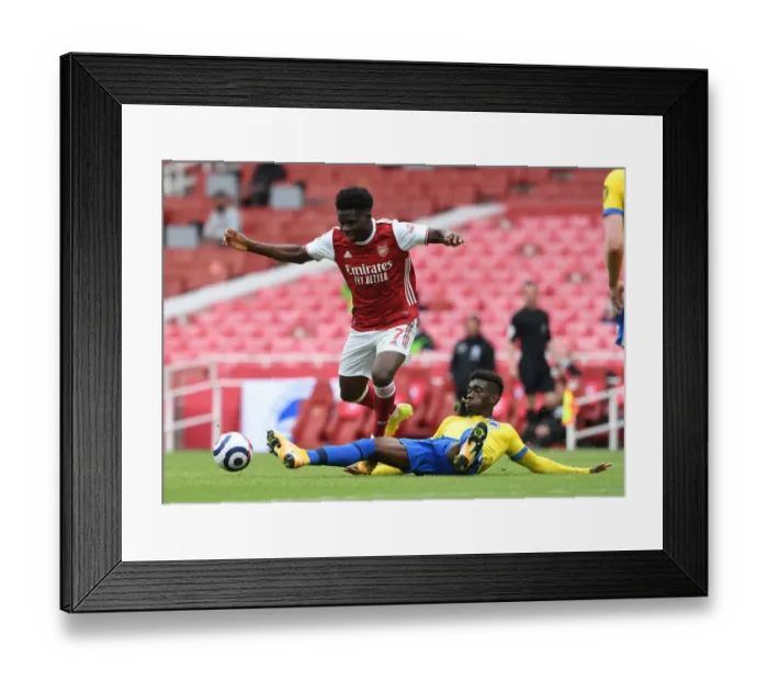 Framed Print : Saka vs Bissouma: A Premier League Showdown at Emirates Stadium