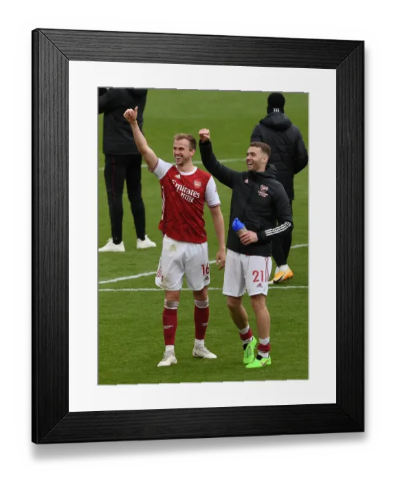 Framed Print : Arsenal's Holding and Chambers: Celebrating Victory Against Brighton in the 2020-21 Premier League