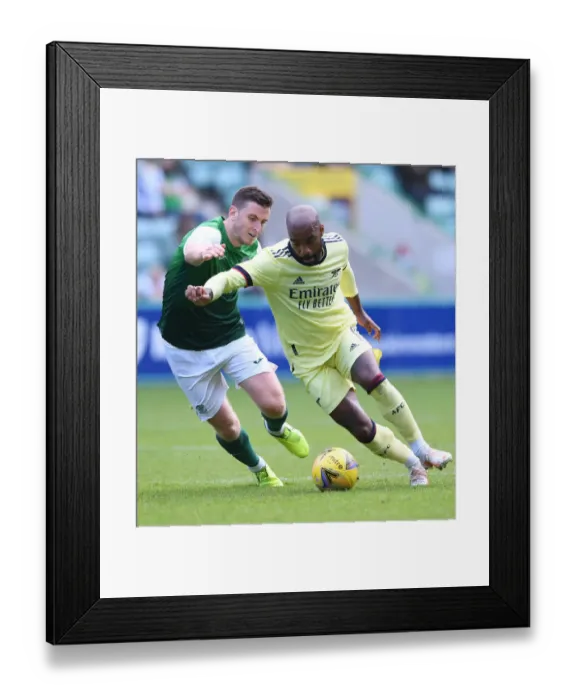 Framed Print : Arsenal's Lacazette Clashes with Hanlon in Hibernian Pre-Season Encounter