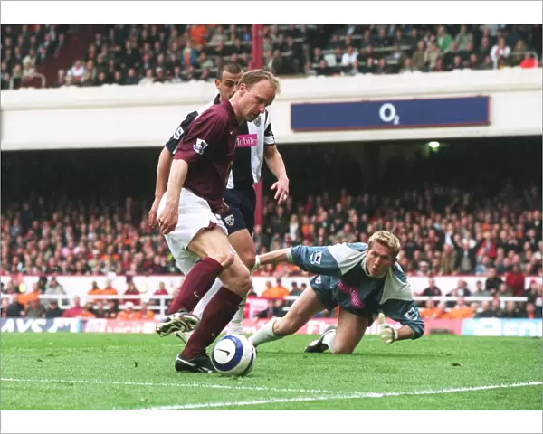 Dennis Bergkamp takes the ball away from Neil Clement and Tomasz Kuszczak