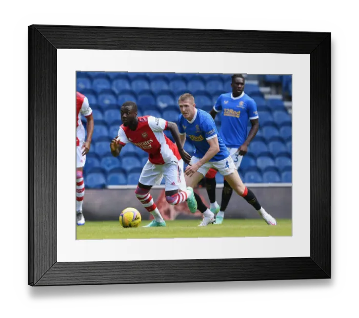 Framed Print : Arsenal's Nicolas Pepe Outmaneuvers Rangers John Lundstram in Pre-Season Clash