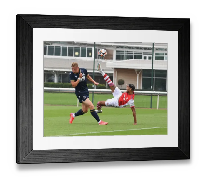 Framed Print : Arsenal's Aubameyang Goes Head-to-Head with Millwall's Ballard in Pre-Season Clash