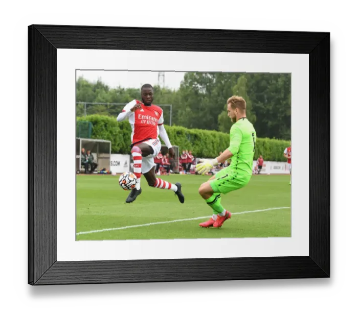 Framed Print : Arsenal's Nicolas Pepe Faces Off Against Millwall's George Long in Pre-Season Friendly