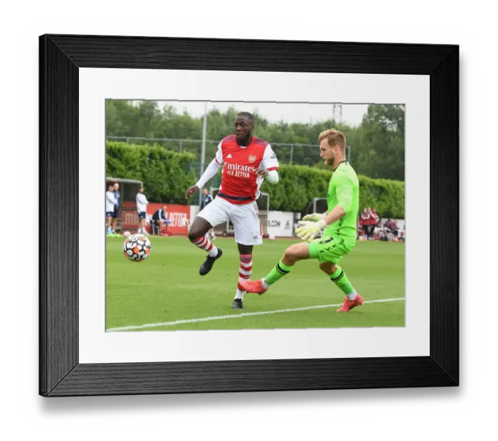 Framed Print : Arsenal's Nicolas Pepe Goes Head-to-Head with Millwall's George Long in Pre-Season Clash Framed Print : Arsenal's Nicolas Pepe Goes Head-to-Head with Millwall's George Long in Pre-Season Clash
