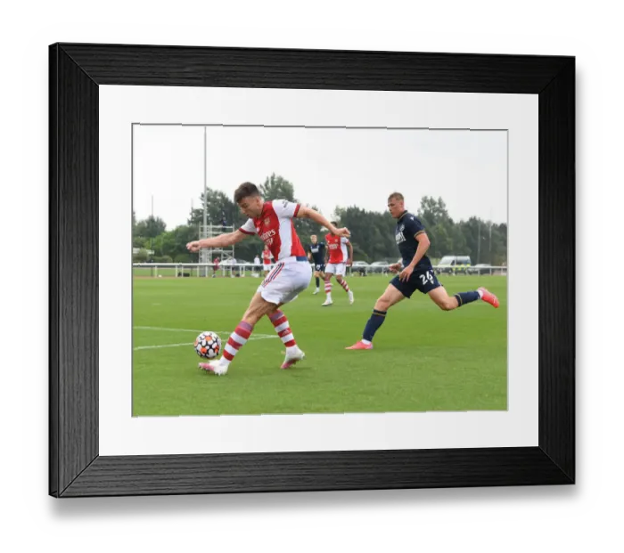 Framed Print : Arsenal's Kieran Tierney Goes Head-to-Head with Millwall's Daniel Ballard in Pre-Season Clash