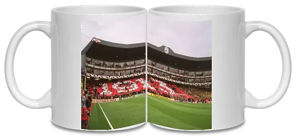 Arsenal fans in the Clock End hold up cards that read 1913