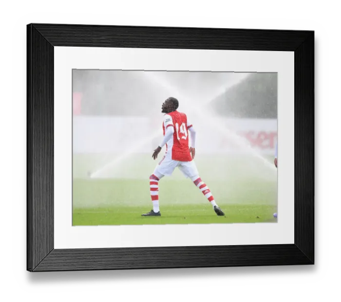 Framed Print : Arsenal's Nicolas Pepe Dodges Pitch Sprinklers Before Arsenal v Watford Pre-Season Friendly Framed Print : Arsenal's Nicolas Pepe Dodges Pitch Sprinklers Before Arsenal v Watford Pre-Season Friendly