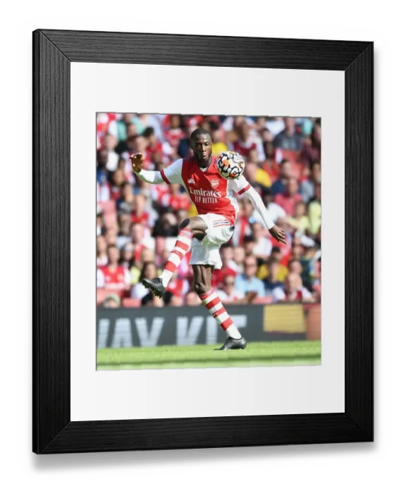 Framed Print : Arsenal's Pepe Demonstrates Unwavering Determination in Arsenal vs Chelsea Pre-Season Clash at Emirates Stadium