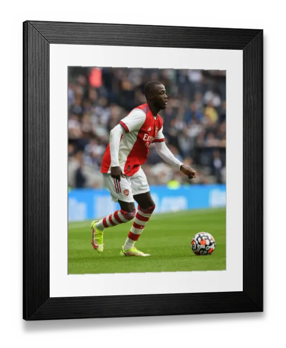 Framed Print : Arsenal's Nicolas Pepe Faces Off Against Tottenham Hotspur in Intense Showdown Framed Print : Arsenal's Nicolas Pepe Faces Off Against Tottenham Hotspur in Intense Showdown