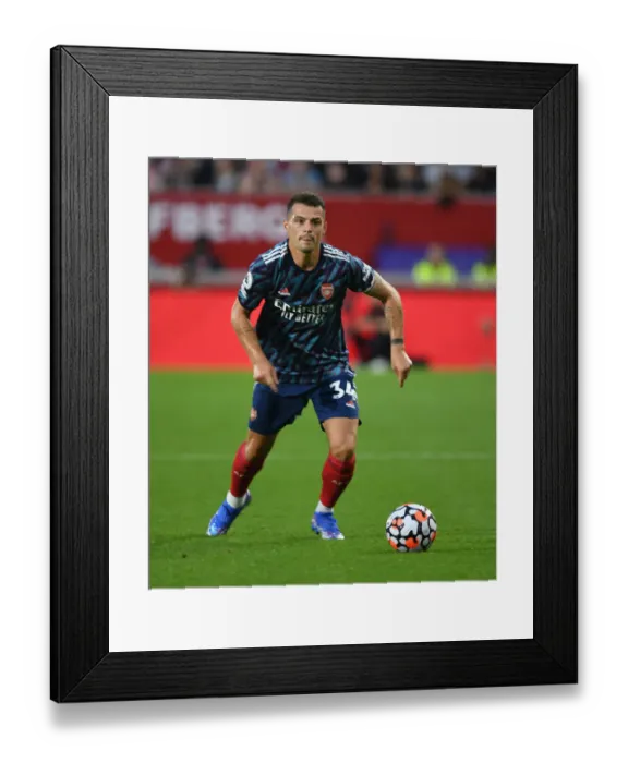 Framed Print : Granit Xhaka: Arsenal's Midfield Maestro Shines in 2021-22 Premier League Debut against Brentford Framed Print : Granit Xhaka: Arsenal's Midfield Maestro Shines in 2021-22 Premier League Debut against Brentford