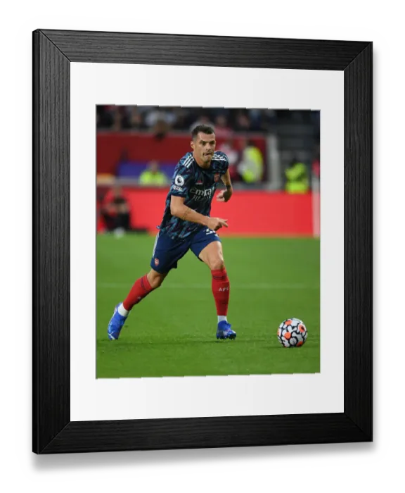Framed Print : Granit Xhaka: Arsenal's Midfield Maestro in Action against Brentford, 2021-22 Premier League Framed Print : Granit Xhaka: Arsenal's Midfield Maestro in Action against Brentford, 2021-22 Premier League