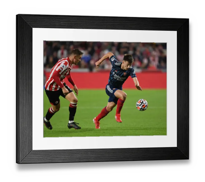 Framed Print : Arsenal's Kieran Tierney Outsmarts Sergi Canos: A Premier League Battle at Brentford