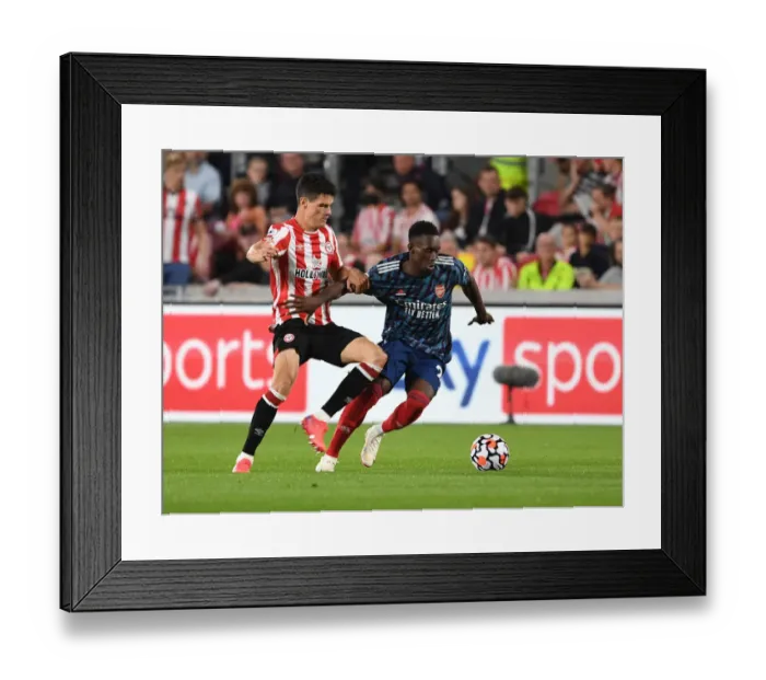 Framed Print : Brentford vs Arsenal: Intense Clash between Flo Balogun and Christian Norgaard in the 2021-22 Premier League