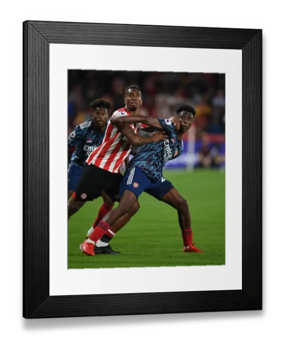 Framed Print : Brentford vs Arsenal: Nuno Tavares and Ivan Toney Clash in Premier League Showdown