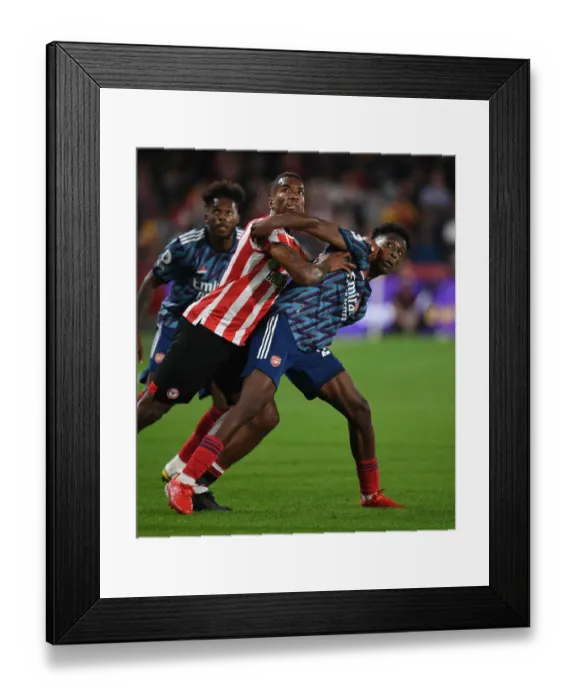 Framed Print : Brentford vs Arsenal: Nuno Tavares Faces Off Against Ivan Toney in Premier League Clash