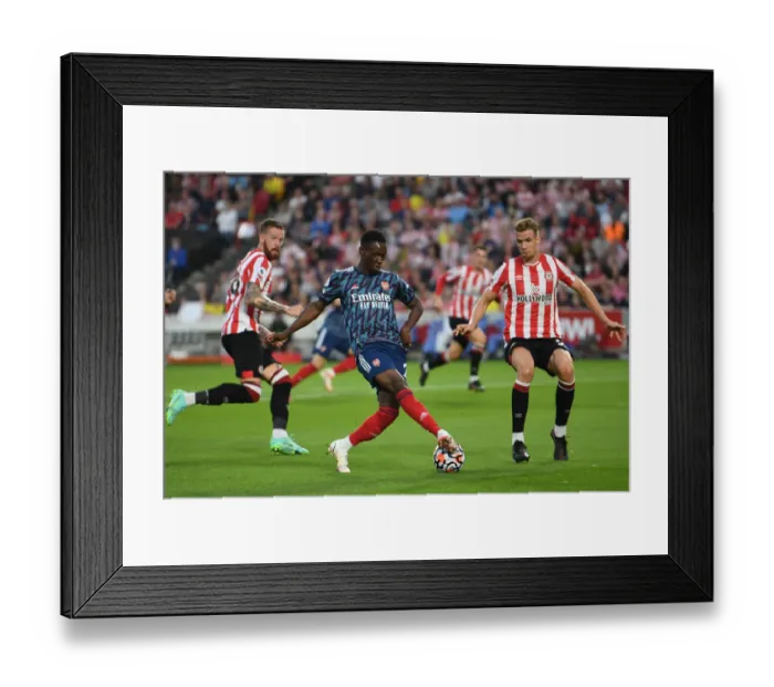 Framed Print : Brentford vs. Arsenal: Flo Balogun's Backheel Battle with Kristoffer Ajer