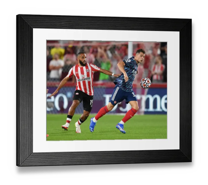 Framed Print : Xhaka vs Mbeumo: A Premier League Battle - Arsenal's Xhaka Clashes with Brentford's Mbeumo (2021-22)