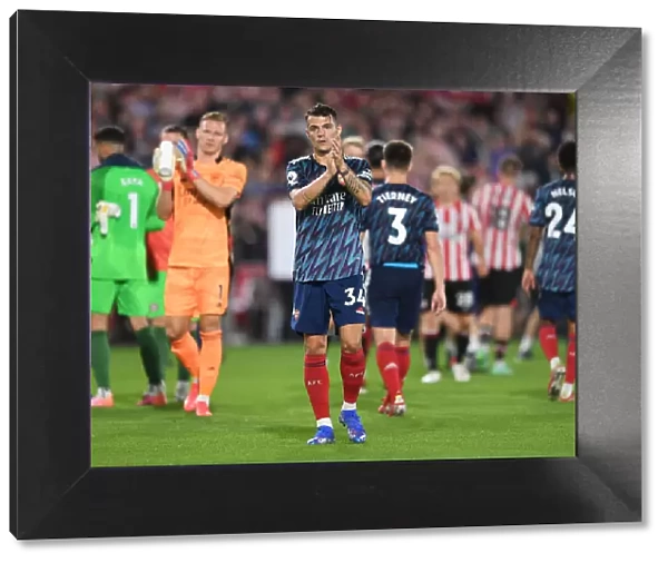 Granit Xhaka Celebrates with Arsenal Fans after Brentford Victory - Premier League 2021-22