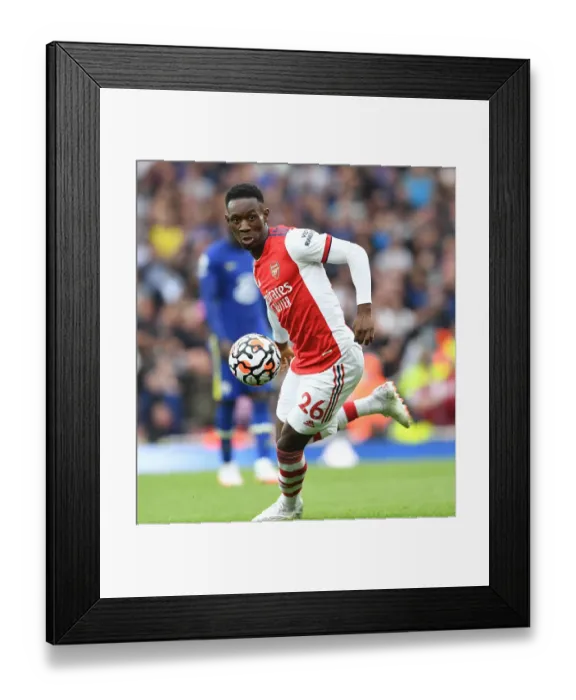 Framed Print : Arsenal vs. Chelsea: Battle for Premier League Glory - Flo Balogun in Action