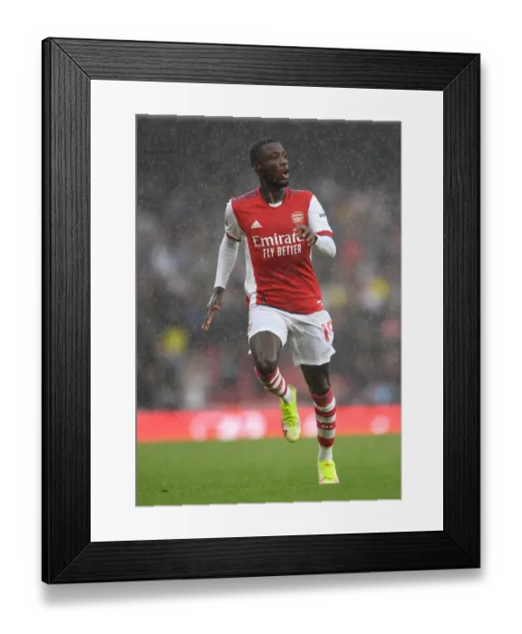Framed Print : Arsenal's Nicolas Pepe Faces Off Against Chelsea in the Premier League Framed Print : Arsenal's Nicolas Pepe Faces Off Against Chelsea in the Premier League