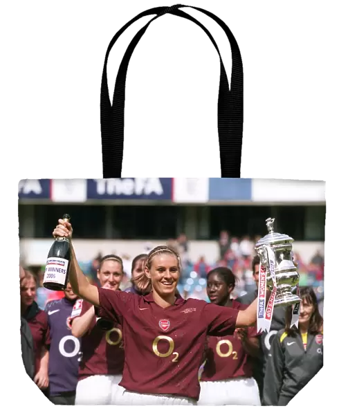 Julie Fleeting lifts the FA Cup Trophy for the Arsenal Ladies