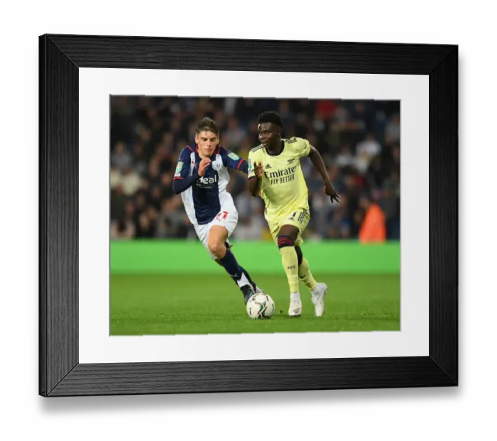 Framed Print : Arsenal's Bukayo Saka Faces Off Against West Bromwich Albion's Tom Fellows in Carabao Cup Clash