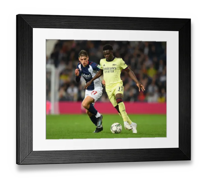 Framed Print : Bukayo Saka vs. Tom Fellows: Arsenal's Star Clashes in Carabao Cup Showdown