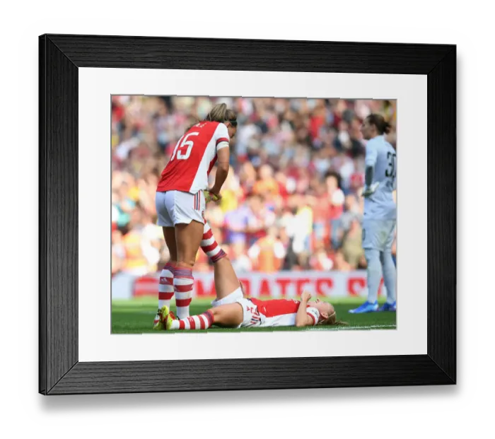 Framed Print : Arsenal Women: Katie McCabe Supports Beth Mead Through Cramp During Arsenal vs Chelsea Match Framed Print : Arsenal Women: Katie McCabe Supports Beth Mead Through Cramp During Arsenal vs Chelsea Match