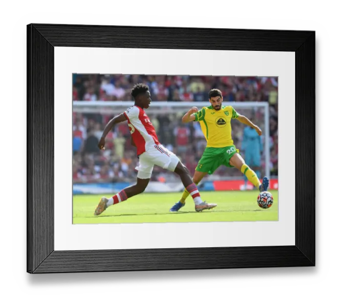 Framed Print : Arsenal's Lokonga Outmaneuvers Norwich's Lees-Melou in Premier League Clash Framed Print : Arsenal's Lokonga Outmaneuvers Norwich's Lees-Melou in Premier League Clash