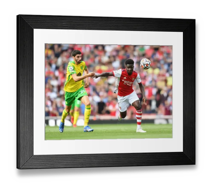 Framed Print : Arsenal's Bukayo Saka Faces Off Against Norwich's Pierre Lees-Melou in Premier League Clash