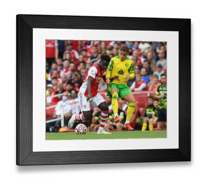 Framed Print : Arsenal's Bukayo Saka Clashes with Norwich's Max Aarons in Premier League Showdown Framed Print : Arsenal's Bukayo Saka Clashes with Norwich's Max Aarons in Premier League Showdown