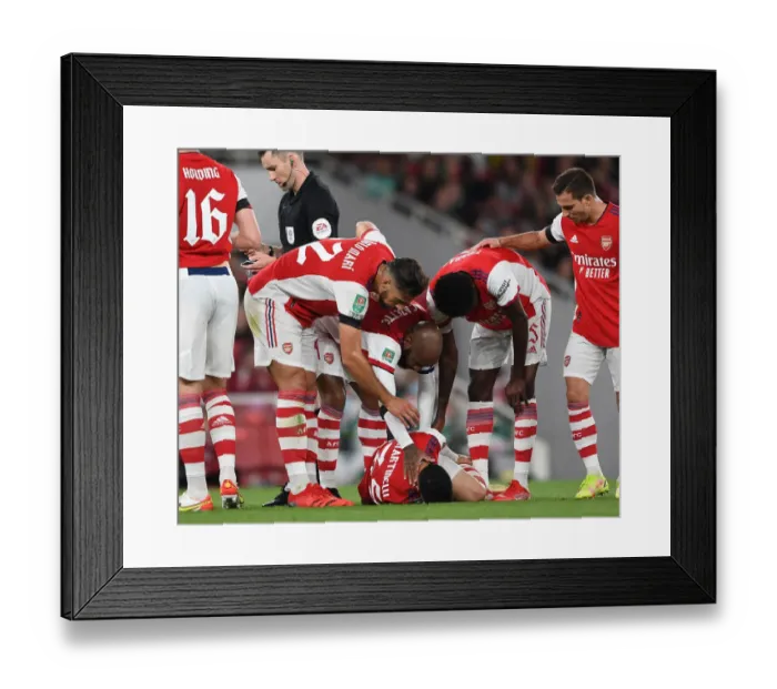 Framed Print : Arsenal Tend to Their Injured Star: Martinelli Attended by Lacazette, Mari, and Partey vs AFC Wimbledon (2021-22 Carabao Cup)